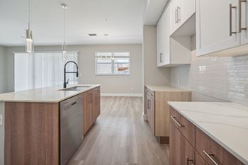 A large kitchen with wooden cabinets and white counter tops